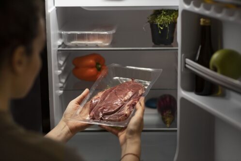 high-angle-woman-holding-meat
